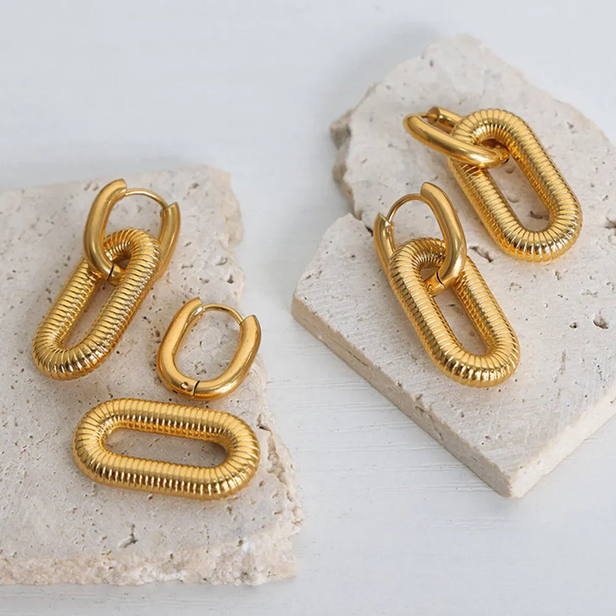 Gold textured oval link hoop earrings and single oval link earrings.