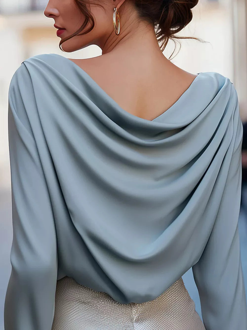 Sky blue cowl neck long sleeve shirt with draped back detail.