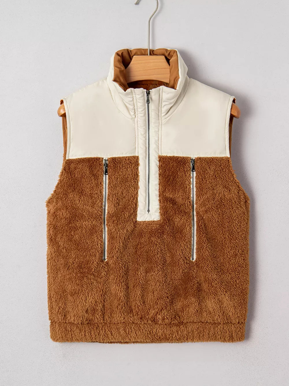 Cozy color block vest coat in brown sherpa and beige nylon with quarter zip and zippered pockets.