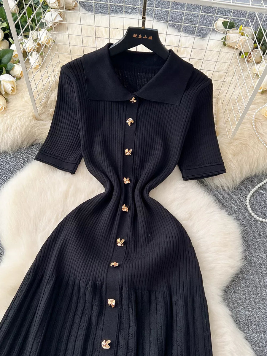 Black knit Peter Pan collar dress with gold button details and short sleeves.