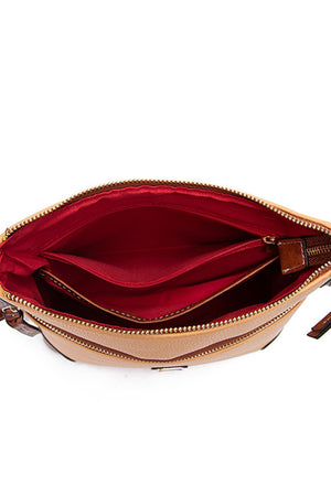 Golden Hour Leather Crossbody bag in tan with red interior and multiple compartments.