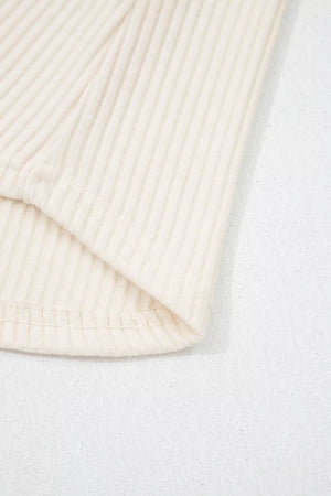 Ribbed cream shirt detail showing texture and hem