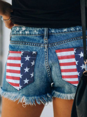 Denim shorts with American flag pocket details and frayed hem