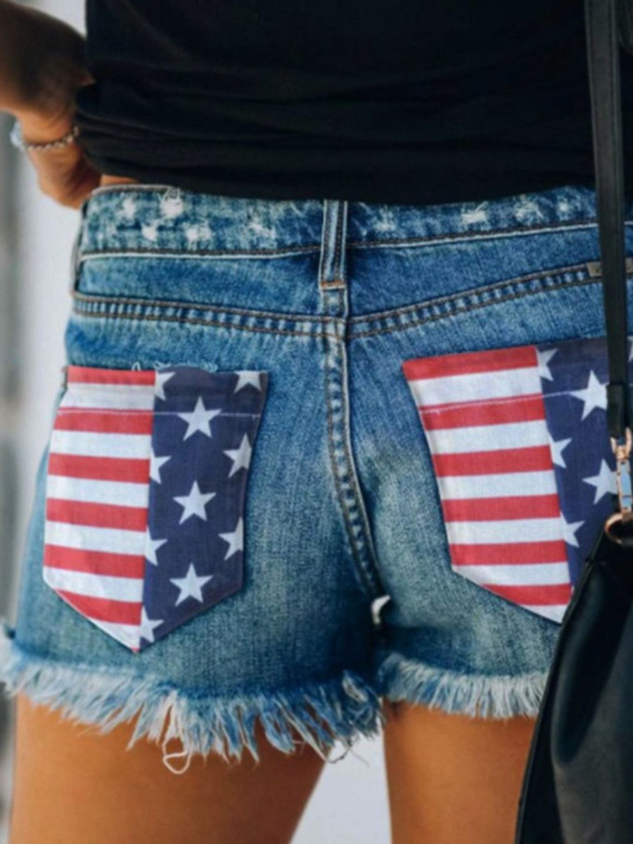 Denim shorts with American flag pocket details and frayed hem
