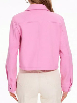 Pink trucker jacket with snap buttons and long sleeves, cropped length.