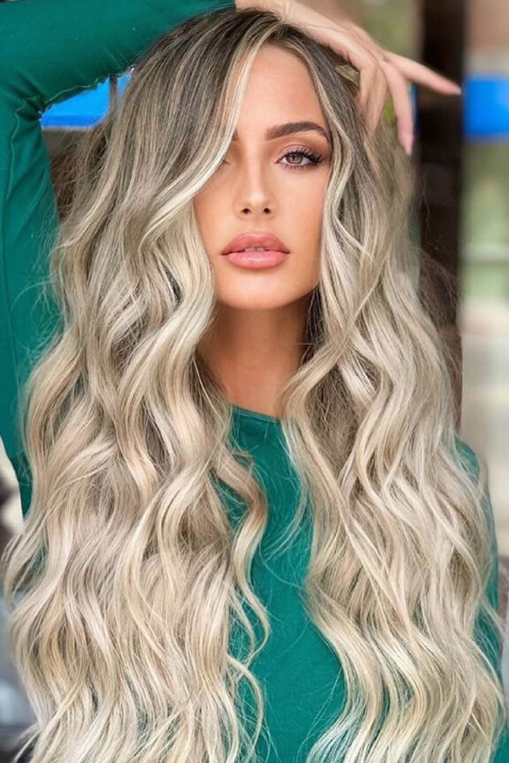 Ombre beach wave wig with face framing in light brown blonde balayage, styled casually.