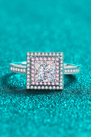 Princess cut halo ring in silver with pink accents and a central square diamond.