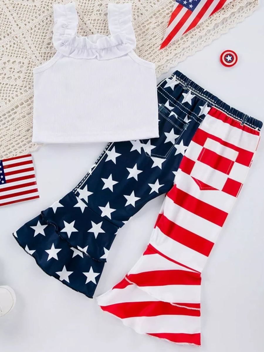 White ruffle tank top with patriotic star print and striped bell bottom pants.