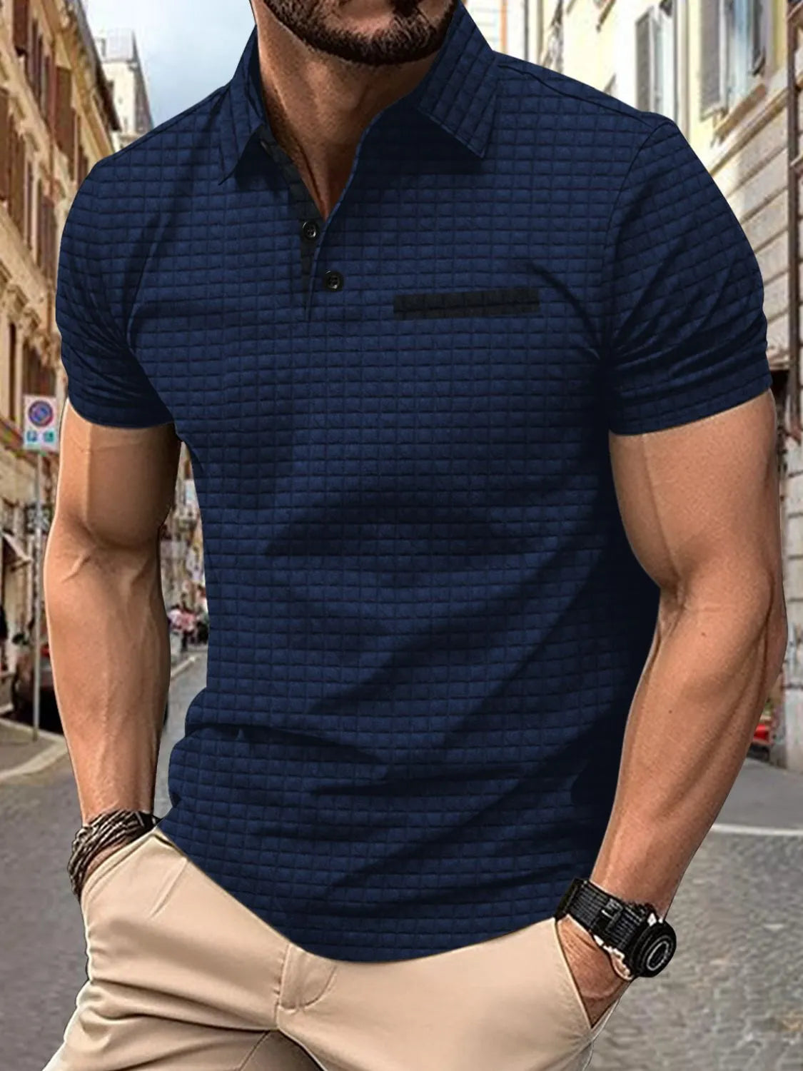 Navy textured polo shirt with contrast pocket detail and short sleeves.