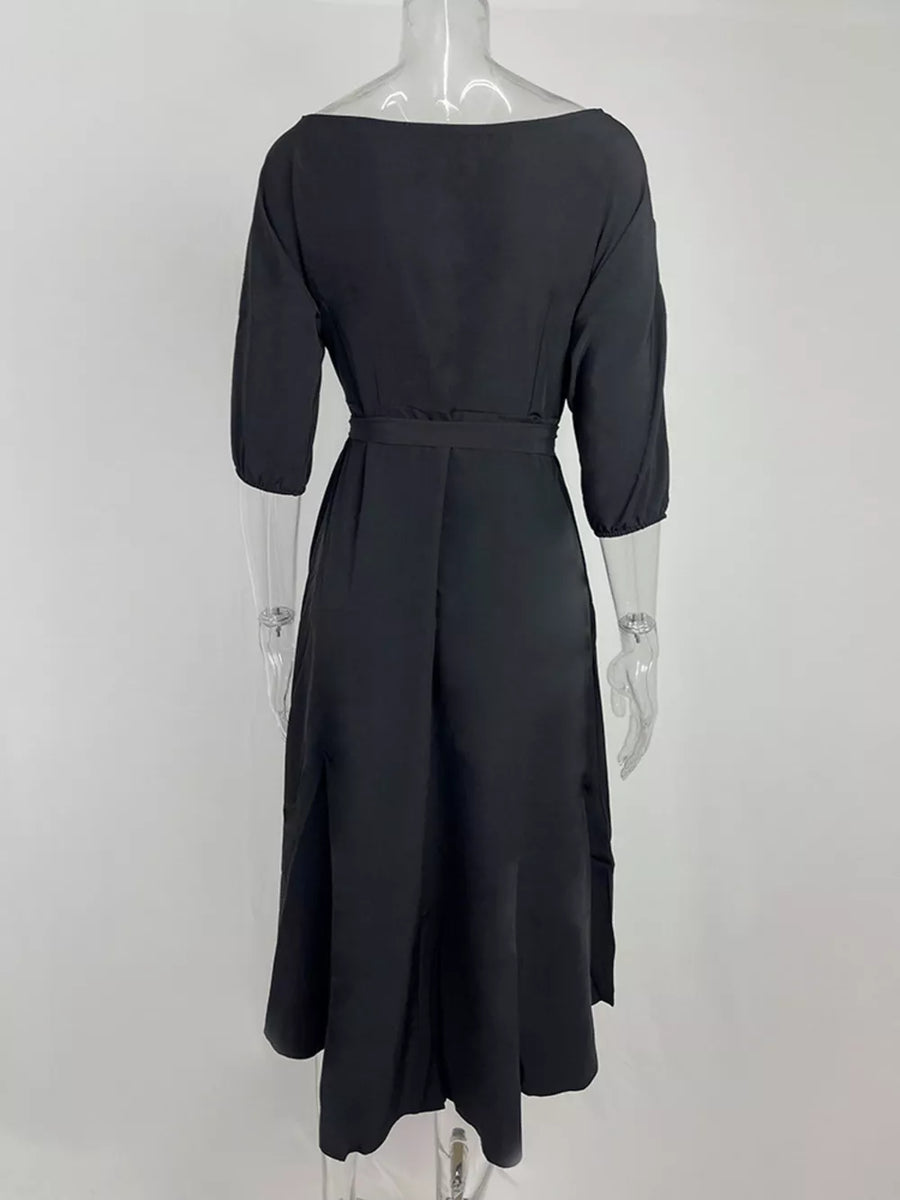 Black off-the-shoulder belted midi dress with 3/4 sleeves and a flared skirt.