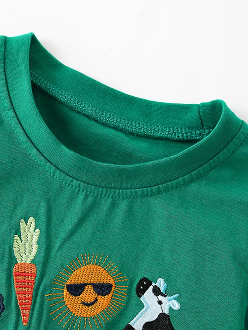 Green cotton blend toddler t-shirt with embroidered carrot, sunglasses-wearing sun, and cow details.