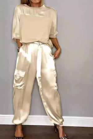 Beige satin two-piece outfit set with crew neck top and cargo pants.