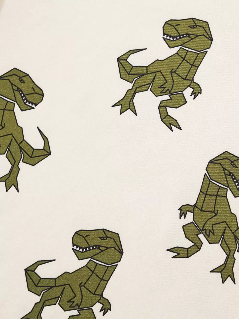 Cream cotton baby tee with geometric green dinosaur print