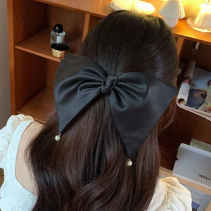 Black hair clip with pearl embellishment and not applicable