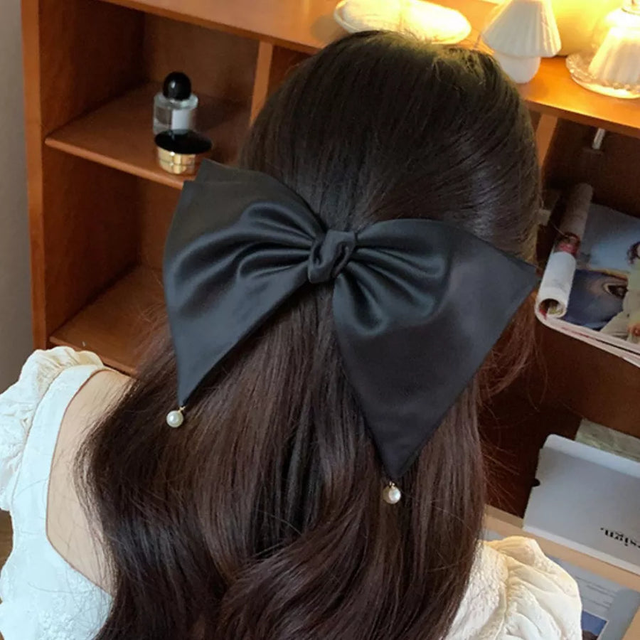 Black hair clip with pearl embellishment and not applicable