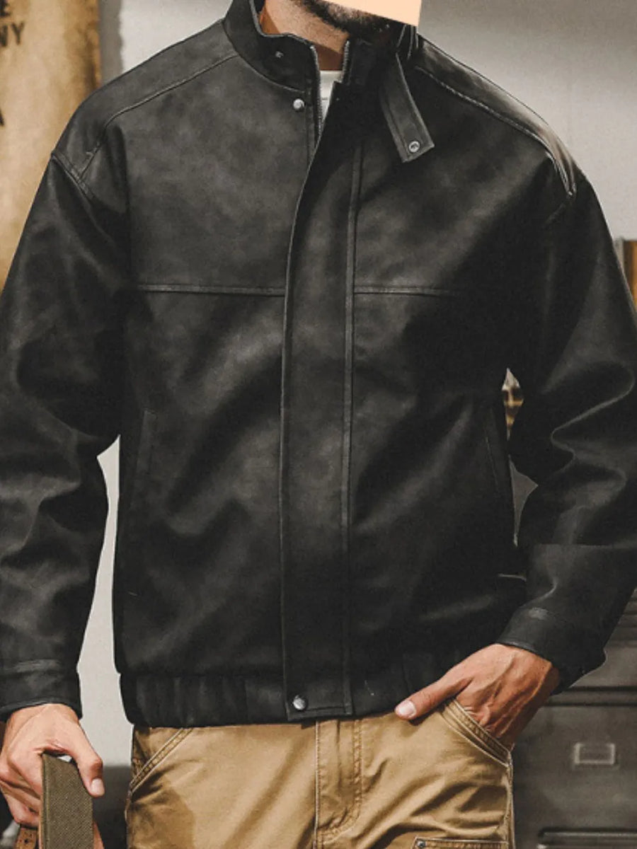 Black distressed leather bomber jacket with stand collar and snap details.