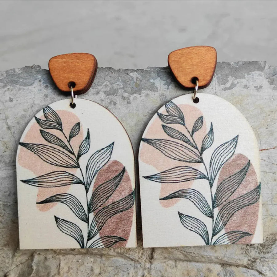 Botanical arch wood earrings in apricot with abstract leaf print and wooden top detail.