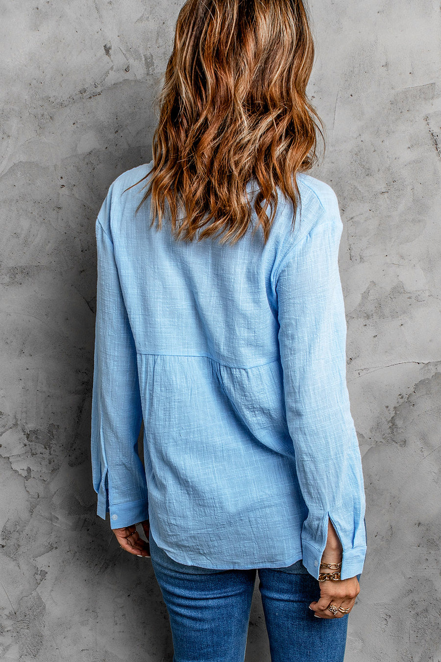 Light blue textured cotton relaxed fit shirt with button cuffs and a tiered bodice detail.