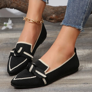 Black knit bow loafers with contrast trim and pointed toe.