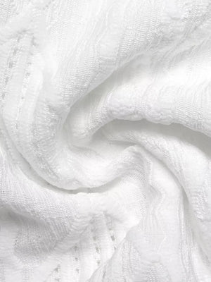 White textured knit maternity t-shirt with openwork detail and bow accent.