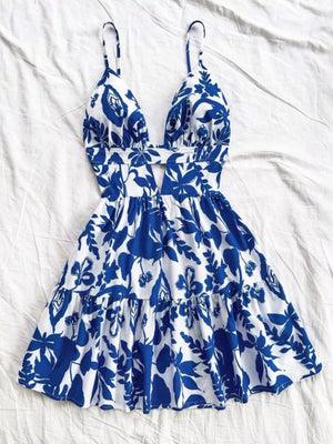 Vibrant floral print mini dress with V-neck, cutout detail, and tiered ruffle skirt.