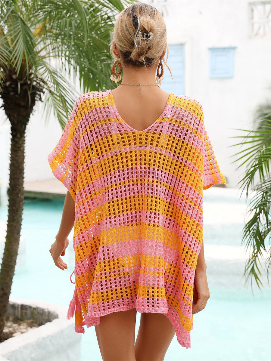Striped crochet beach cover-up in pink and orange with drawstring detail.