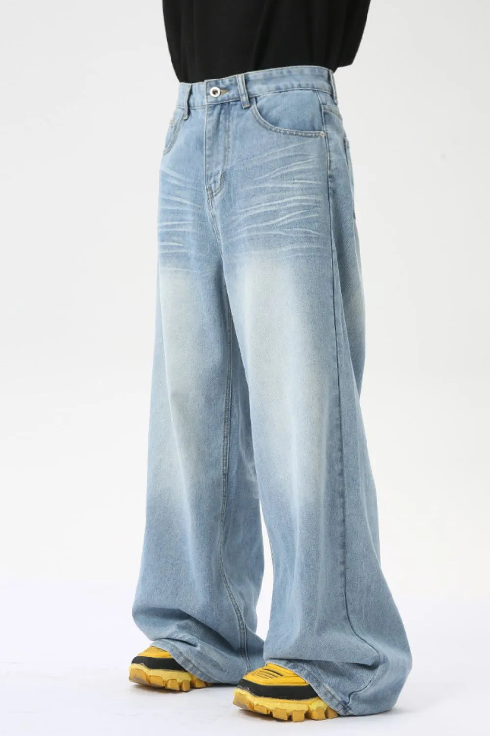 Oversized wash denim palazzo trousers in medium blue with a wide leg and faded details.
