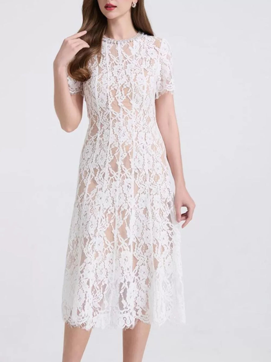 White lace midi dress with short sleeves and pearl embellishments at the neckline.