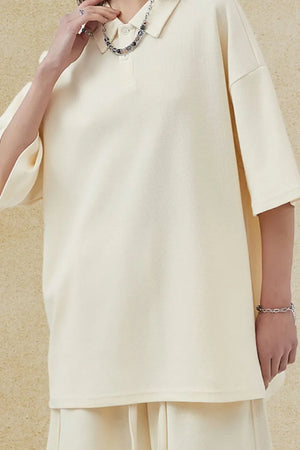 Boxy textured polo shirt in ivory with a relaxed fit and short sleeves.