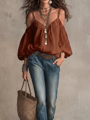Caramel cold shoulder balloon sleeve shirt with spaghetti straps and V-neck, styled with jeans.