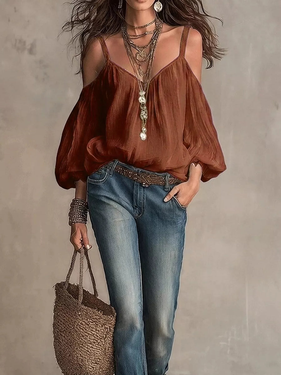 Caramel cold shoulder balloon sleeve shirt with spaghetti straps and V-neck, styled with jeans.