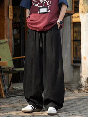 Black wide leg sweatpants with drawstring waist and pockets.