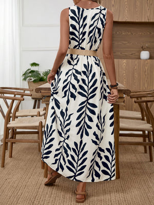 Belted midi dress with a tropical leaf print, natural fiber belt, and sleeveless design.