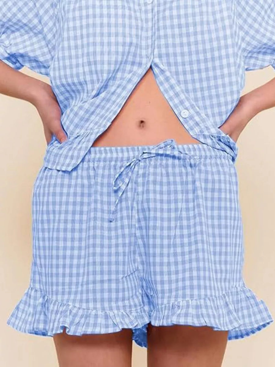 Blue gingham two-piece set with button-front top and ruffle-trim shorts.