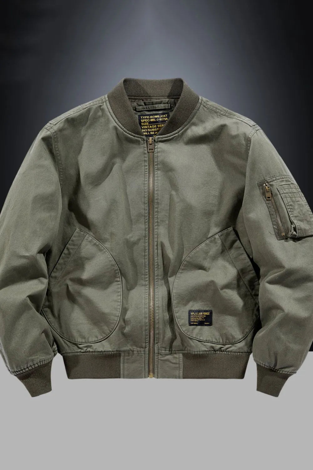Army green bomber jacket with patch detail, zippered pockets, and ribbed cuffs.