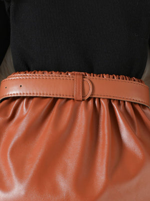 Toddler black ribbed top with a brown faux leather skirt and matching belt.