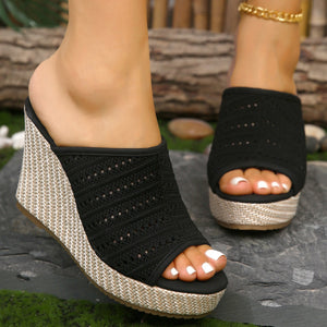 Black perforated espadrille wedge sandals with woven espadrille platform.