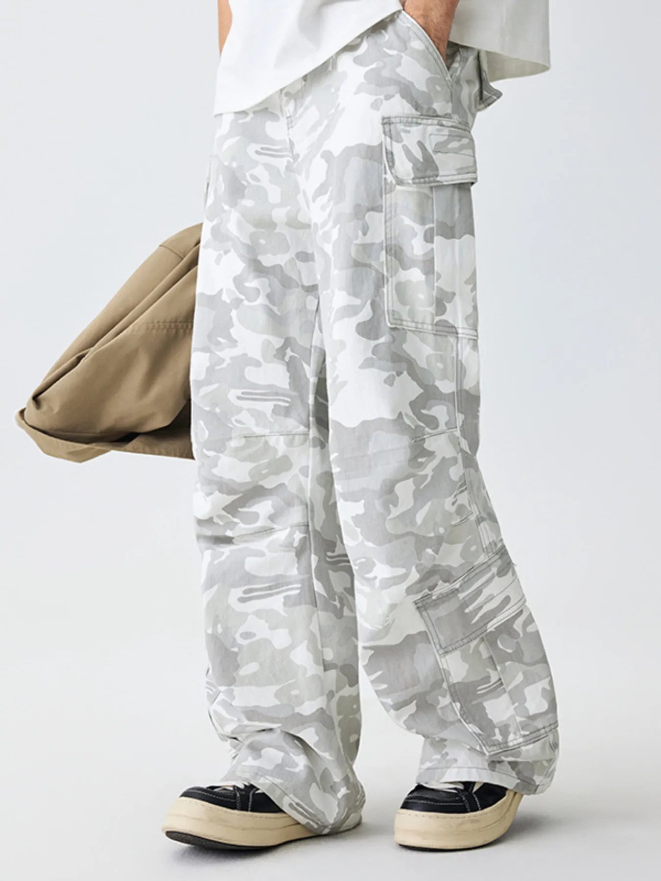 Relaxed fit cargo pants in snow camouflage pattern with multiple pockets.
