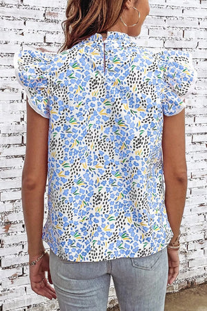 Floral abstract high neck blouse with cap sleeves and ruffled details.
