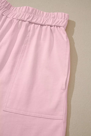 Blush pink pajama shorts with elastic waistband and patch pocket detail.