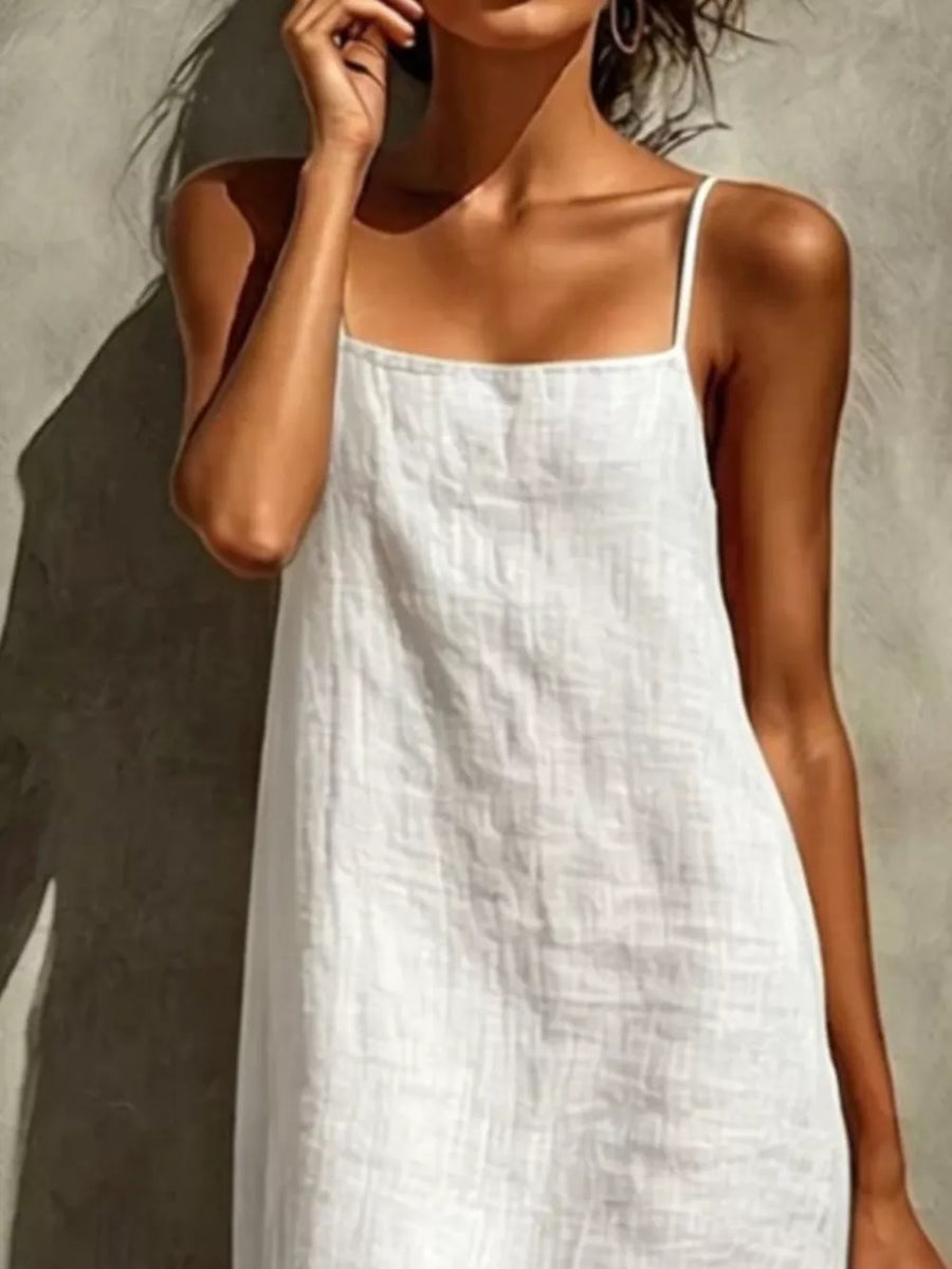 White linen-blend maxi dress with square neckline and spaghetti straps.