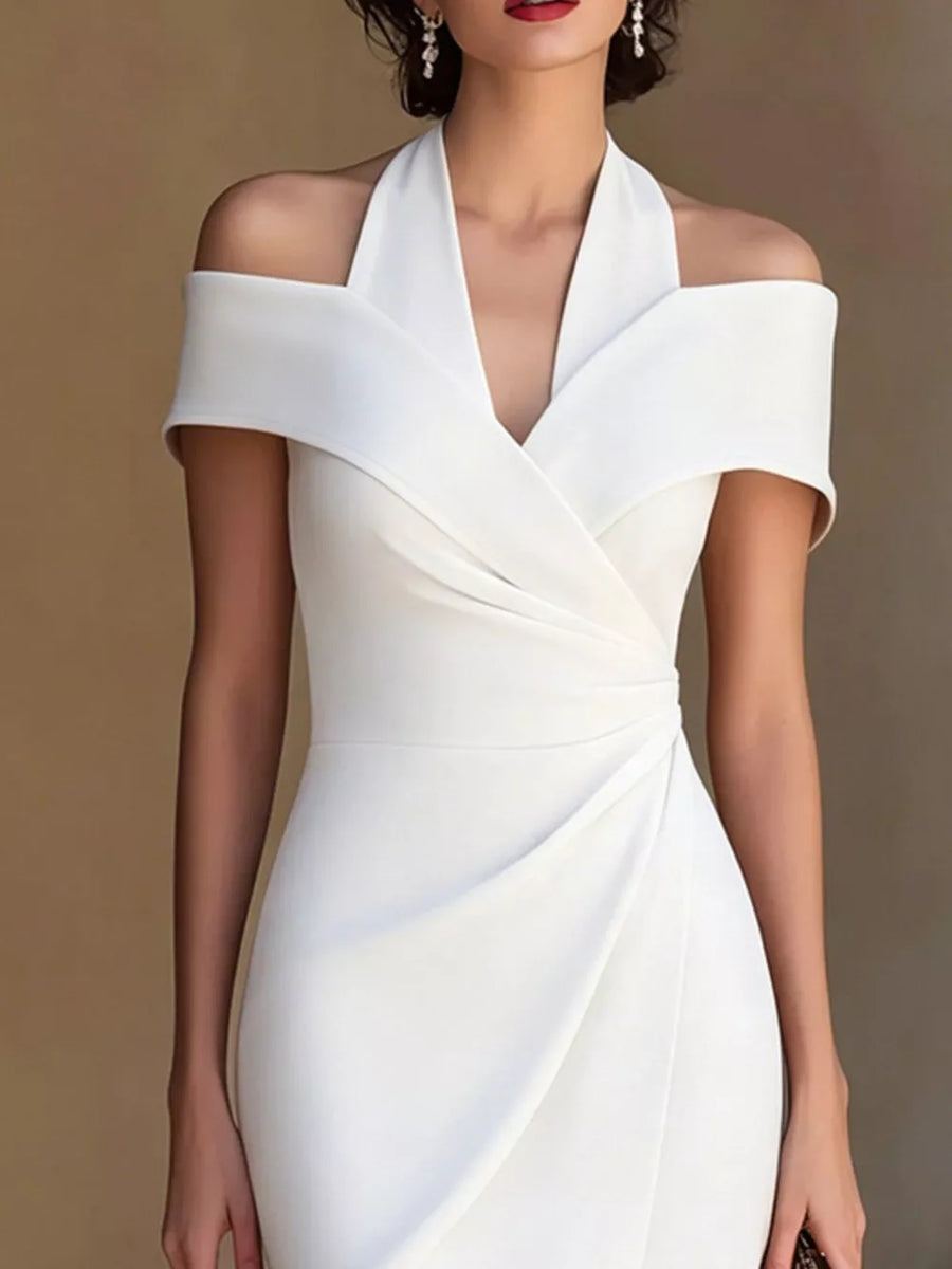 White asymmetrical midi dress with halter neckline and off-shoulder sleeves.