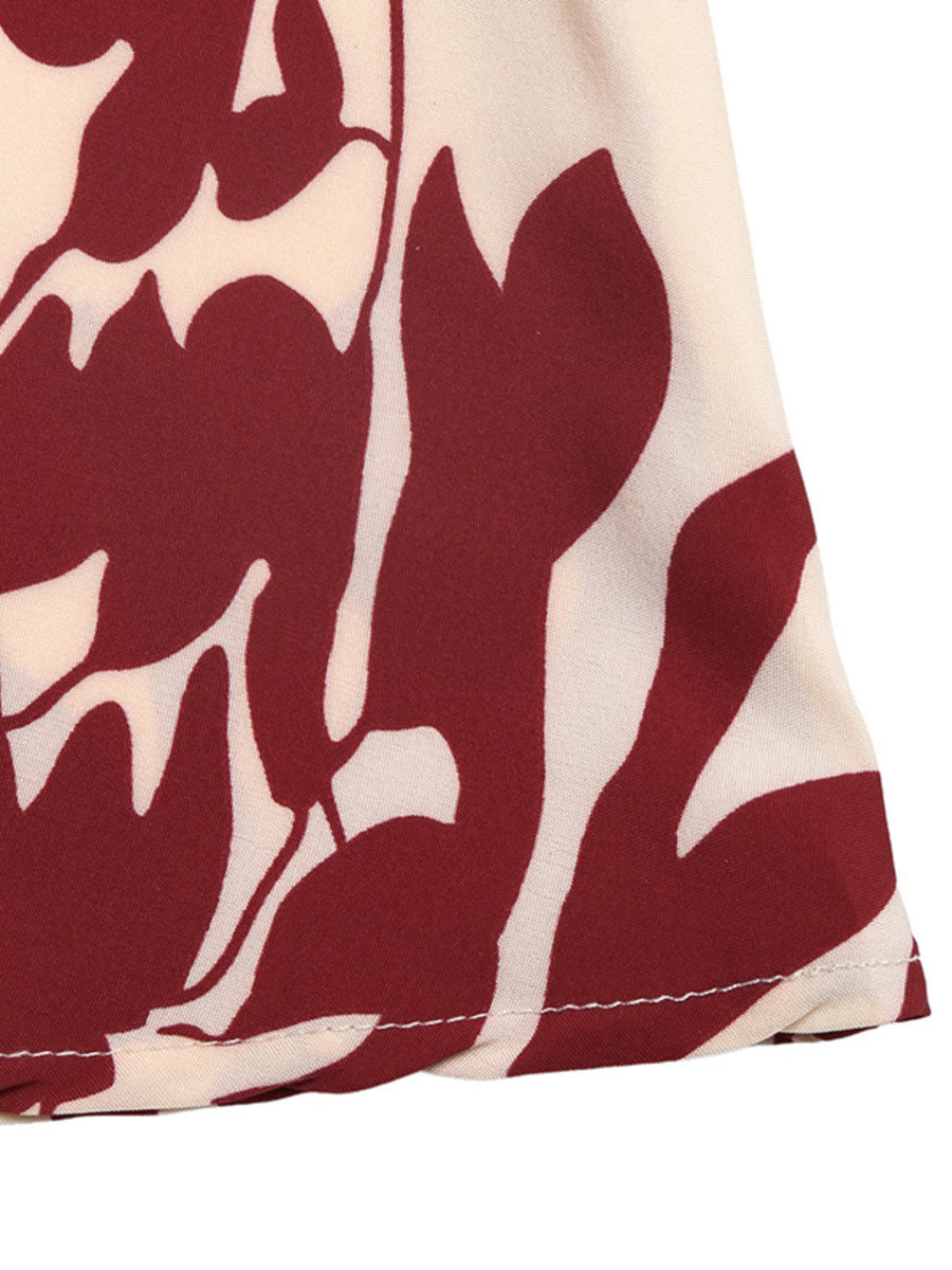 Maxi dress with a bold floral print in burgundy and cream, featuring a deep V-neck.