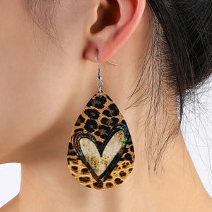 Leopard print teardrop earrings with a distressed heart detail.