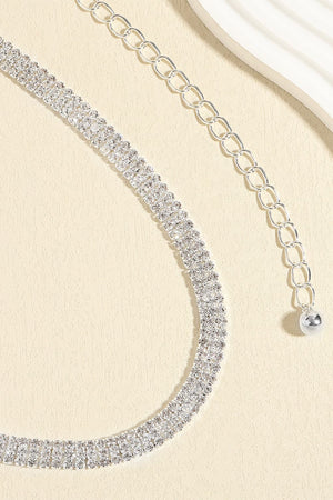 Triple-row crystal waist chain in silver with adjustable link closure and ball charm.