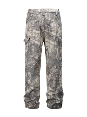 Distressed camo carpenter jeans in gray with multiple pockets and a relaxed fit.