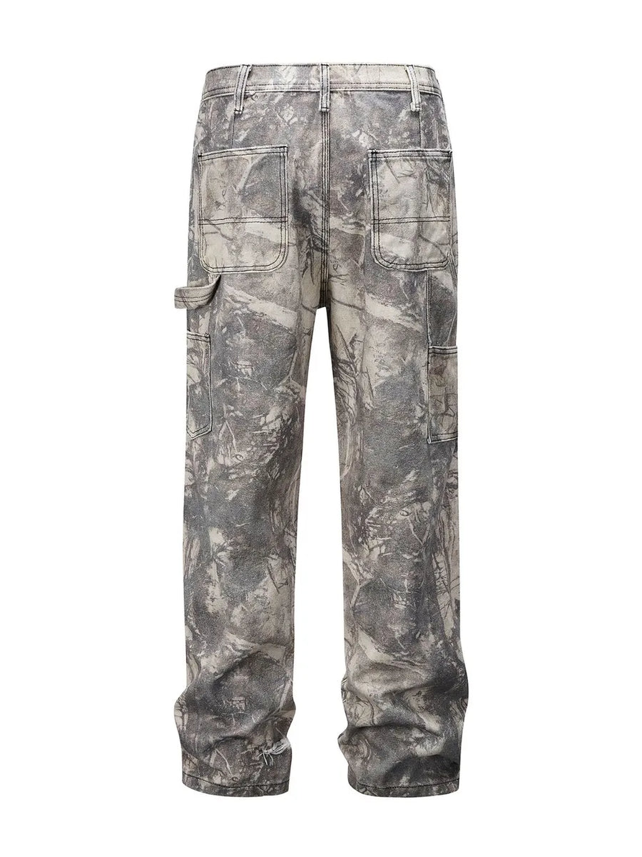 Distressed camo carpenter jeans in gray with multiple pockets and a relaxed fit.