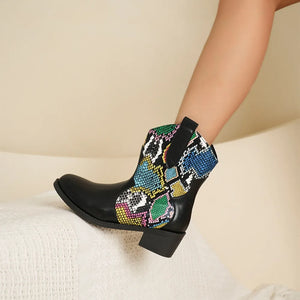 Python print western booties in snakeskin with black leather and a low heel.