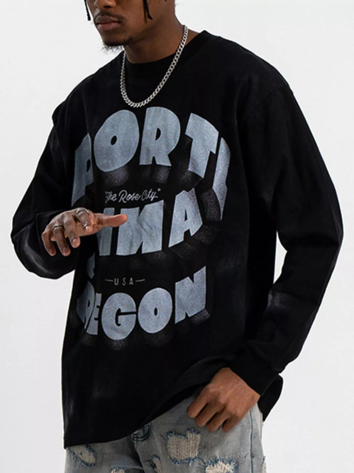 Black oversized long-sleeve tee with bold grey graphic text and a comfortable cotton blend.
