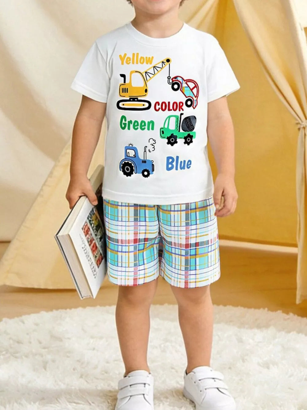Baby boys white cotton tee with colorful construction vehicles and plaid shorts.